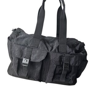 Tommy Bahama black travel duffle bag with hand and shoulder straps